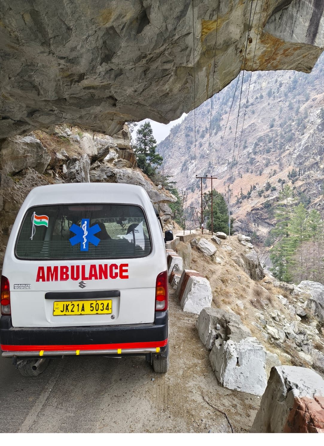 Bittu ambulance with Indian flag on a Himalayan mountain road in J&K