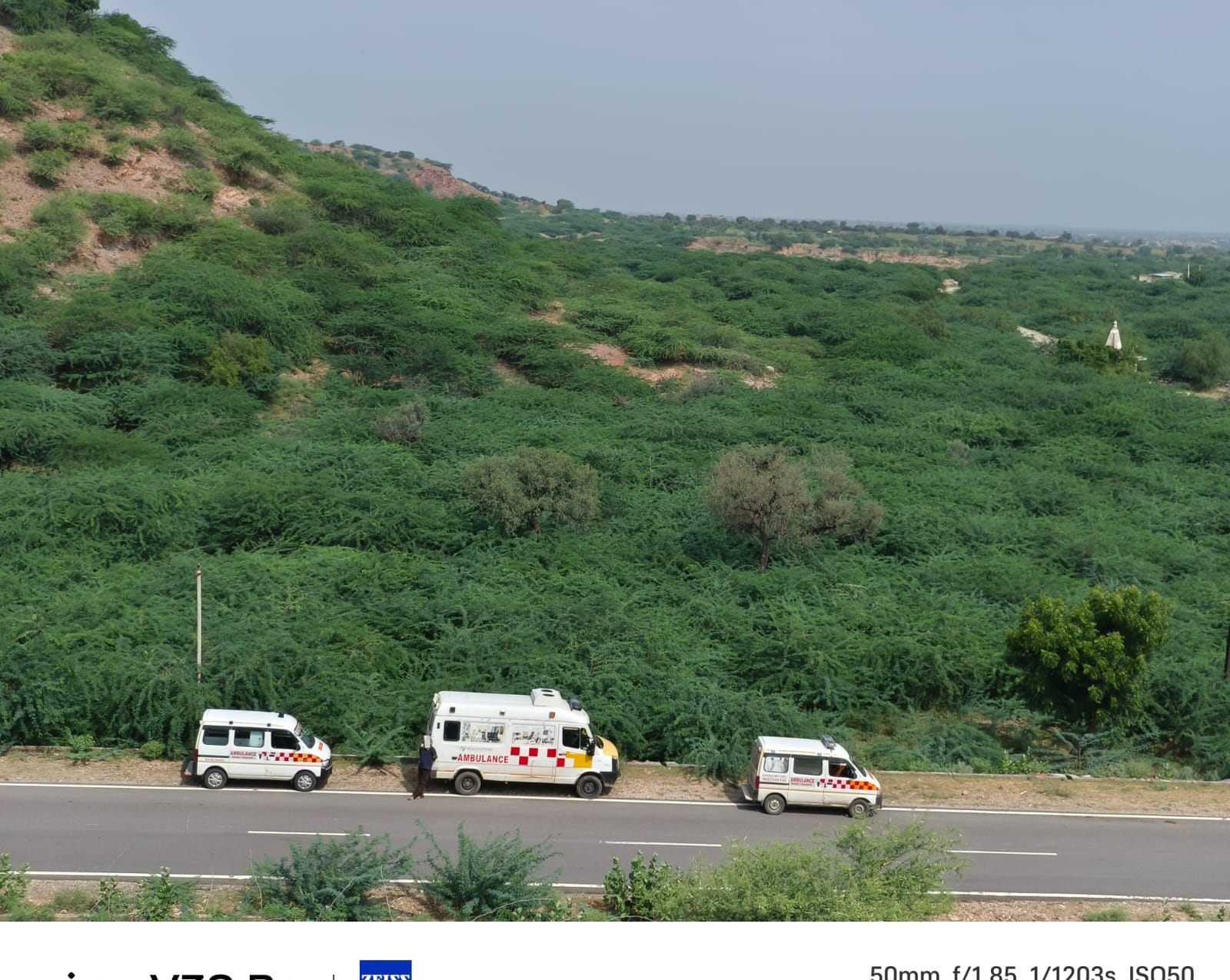 Three Bittu ambulances lined on a green hill road
